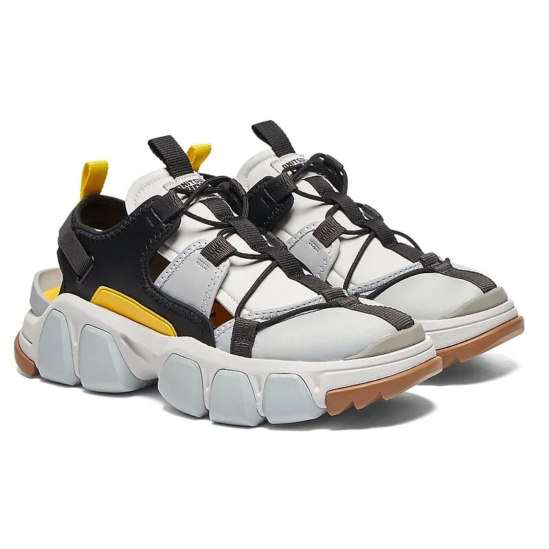 The ONITSUKA TIGER DENTIGRE CAGE is a bold hybrid model that merges sneaker functionality with sandal aesthetics.